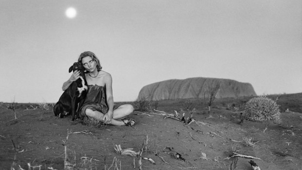 A black and white photo of Robyn Davidson at Uluru, first printed in 2014.