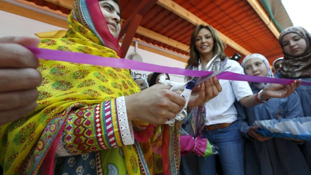 Malala Yousafzai cuts a ribbon near Noura Jumblatt (centre), founder of the Kayany Foundation, at the foundation's school for Syrian refugee girls.