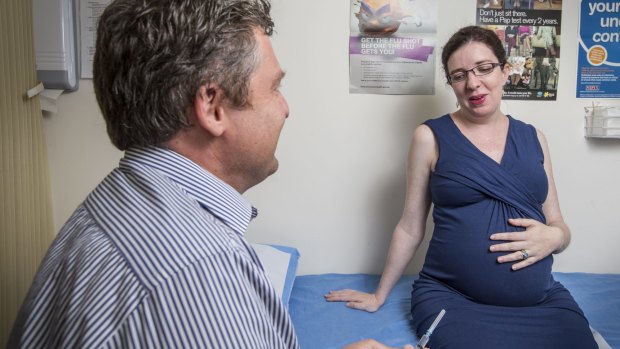 Eleonor Prichard, who is in her final trimester of pregnancy, has a consultation with Dr Martin Liedvogel following the ACT government announcement of free whooping cough shots for pregnant women.