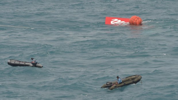 Part of the tail of AirAsia flight QZ8501 floats on the water's surface. 