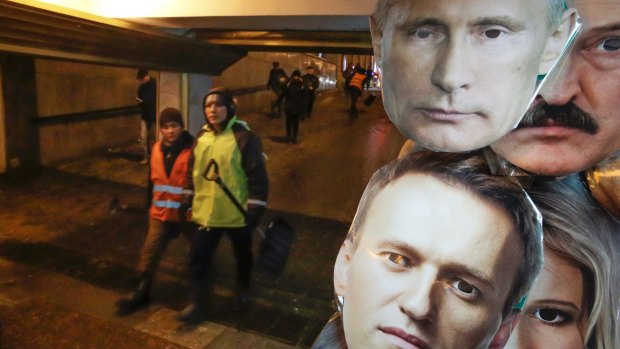 Face masks depicting Russian President Vladimir Putin, top, and Russian opposition leader Alexei Navalny, among others displayed for sale at a street souvenir shop in St.Petersburg, Russia.