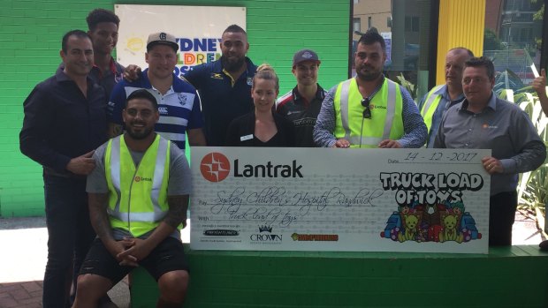Bulldogs players Reni Matua, third from left, Greg Eastwood, fourth from left, and Frank Pritchard, fifth from left, at the children's hospital at Randwick