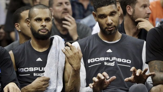 In harmony: San Antonio Spurs guard Patty Mills plays air guitar and veteran Tim Duncan joins in on the keyboards as they play along with music from the arena loudspeakers during a timeout in the second half of Game 4 against the Grizzlies in Memphis.