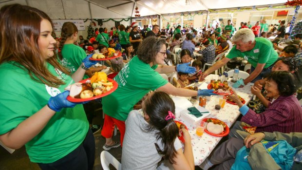 Volunteers serve some of the almost 3000 poor and homeless people at the Exodus Foundation lunch in Ashfield on Christmas day.