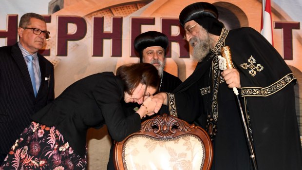 Pope Tawadros II is greeted by NSW Premier Gladys Berejiklian at a welcoming reception in Sydney.