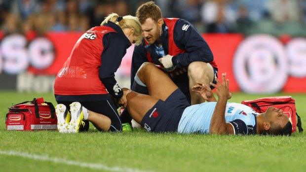 Down and out: Kurtley Beale was stretchered off in the opening minute of the Waratahs' game against the Bulls.