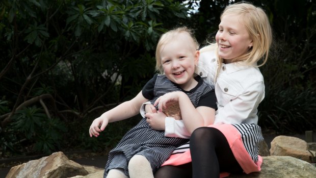 For the past four years, Evie, left has been taking powerful drugs and undergoing neurosurgery and chemotherapy to beat the cancer.