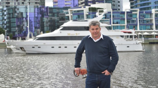 Gene Neill with his luxury vessel Missy B which is berthed at Docklands. The Melbourne council wants it moved because of its size.