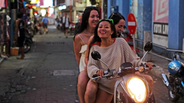 Street run in Bali: 10 per cent of Australians travelling overseas in 2015-16 rode a motorcycle or moped during their travels, a survey shows.