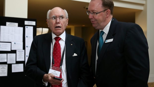 Steps Group Australia executive officer Stuart Coward shows former prime minister John Howard the fake Facebook page.