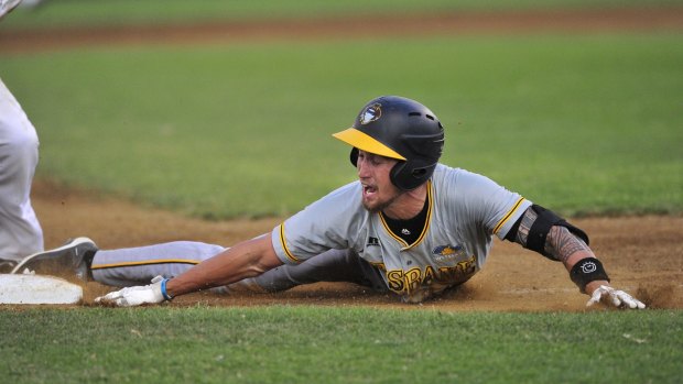 Brisbane Bandits player Aaron Whitefield reacts after being tagged at third base.