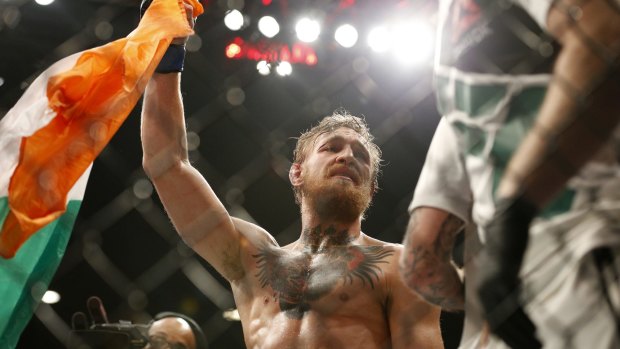 Conor McGregor celebrates after defeating Chad Mendes in their interim featherweight title mixed martial arts bout at UFC 189 Saturday, July 11, 2015, in Las Vegas. (AP Photo/John Locher)