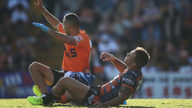 Down and out: Luke Brooks injures his hamstring against the Storm.