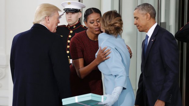 First lady Michelle Obama, flanked by President Barack Obama and President-elect Donald Trump, greets Melania Trump at the White House in Washington, Friday, January 20, 2017. 