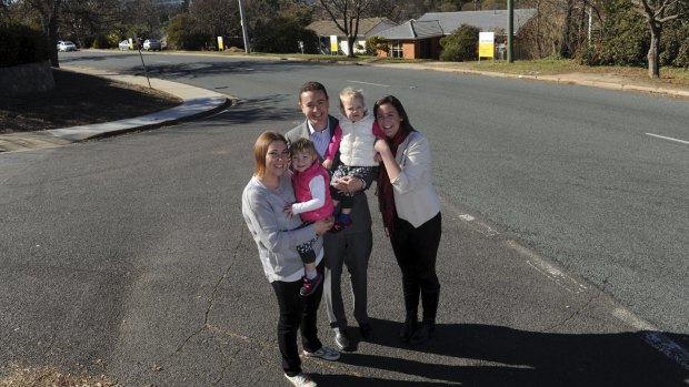  Four adjoining homes in Burnie Street, Lyons, belonging to
members of the Barclay family, will be auctioned together on July 2.
From left, Michelle holding two-year-old twin Ellie, her husband Steven,
holding Asher and Alison, Steven's sister. 