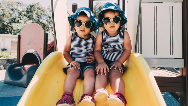 Two-year-old twins Isabella and Madeleine Bodell stay sun smart at Boundless Playground.