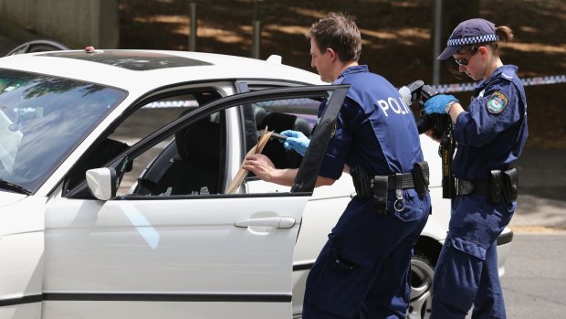 Forensic police remove evidence from the car involved in pursuit across Harbour Bridge.