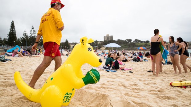 Beachgoers - and a boxing kangaroo - celebrate Australia Day at Coogee Beach.