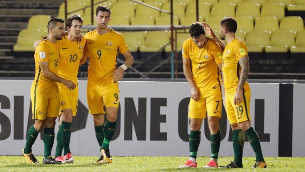 Strong first half: Teammates congratulate Robbie Kruse (10) after his opening goal.