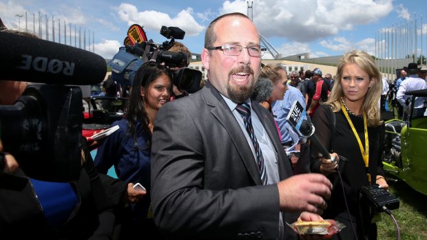 Senator Ricky Muir takes a pie for a walk outside Parliament House.