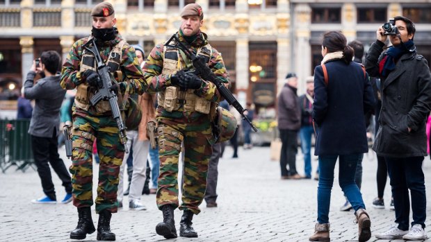 Belgian Army soldiers patrol in the picturesque Grand Place in the centre Brussels. An international manhunt for Belgian-born Paris attack suspect Salah Abdeslam continues.