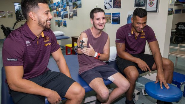 Broncos players Jordan Kahu, left, and Moses Pangai, right, with 18-year-old Bruklan Marshall who was seriously injured in a car crash and is receiving treatment at the Princess Alexandra Hospital.