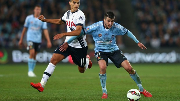 Spurred on: Tottenham's Erik Lamela challenges Terry Antonis during the friendly match in Sydney on Saturday.