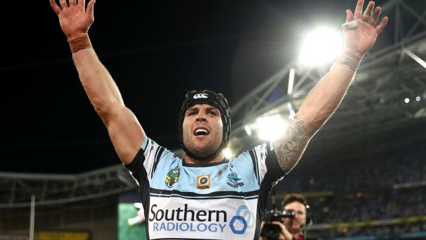 Prime real estate: Michael Ennis celebrates winning the grand final but the Sharks' front-of-jersey sponsorship may be up for grabs.