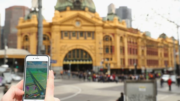 A Pokemon Go player in front of Melbourne's Flinders Street station.