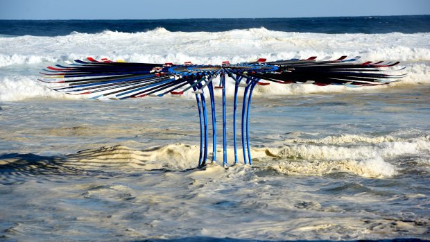 King tide surrounds a sculpture by Rebecca Rose at Tamarama Beach.