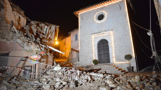 The Church of San Sebastiano stands amidst damaged houses in Castelsantangelo sul Nera.