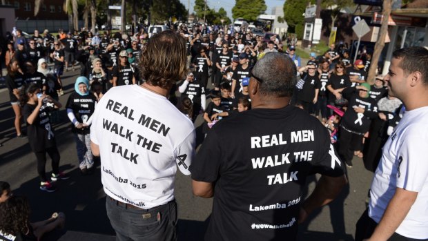 People gather for a White Ribbon Day March in Lakemba in 2015. The day is  just a small part of what is needed to address the multi-layered issue of family violence.
