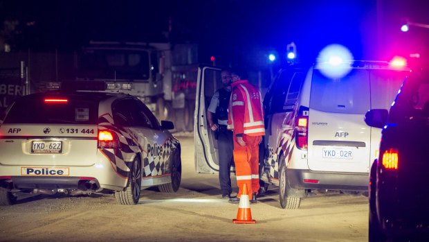 Police and SES staff at the entry to the UC Public hospital building site, where a person died on Thursday night. 