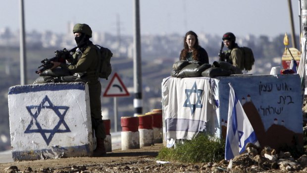 Israeli soldiers stand guard outside settlements in the occupied West Bank in March. The Republican platform rejects the notion that the territory is occupied.