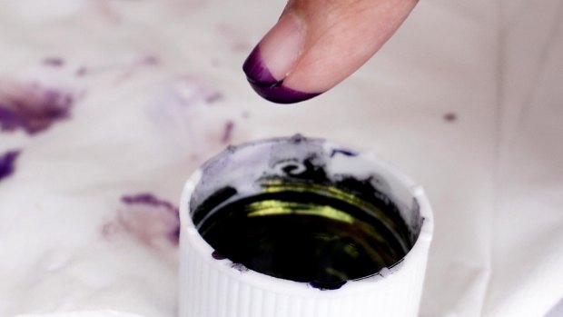 Voters mark their fingers with ink after voting at a polling station in Jakarta on Wednesday.