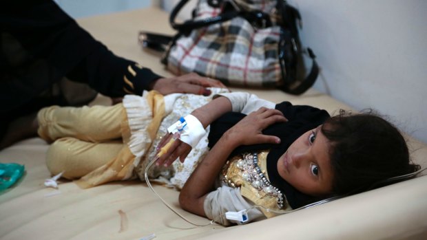 A girl is treated for a suspected cholera infection at a hospital in Sana'a.