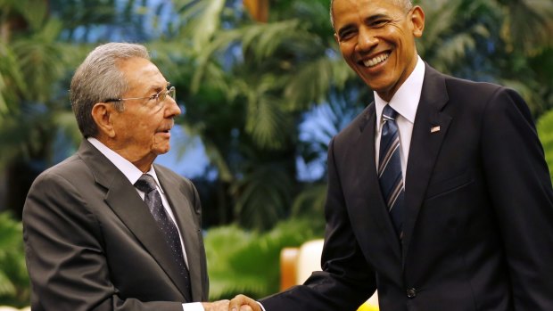 Cuban President Raul Castro, left, shakes hands with US President Barack Obama during a meeting in Revolution Palace on Monday.