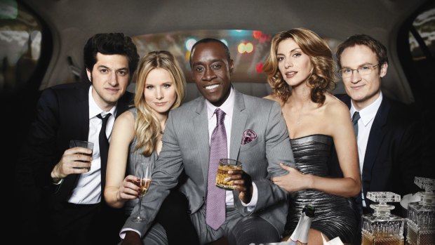 Kristen Bell (second from left) and Don Cheadle (centre) in <i>House of Lies</i>. 