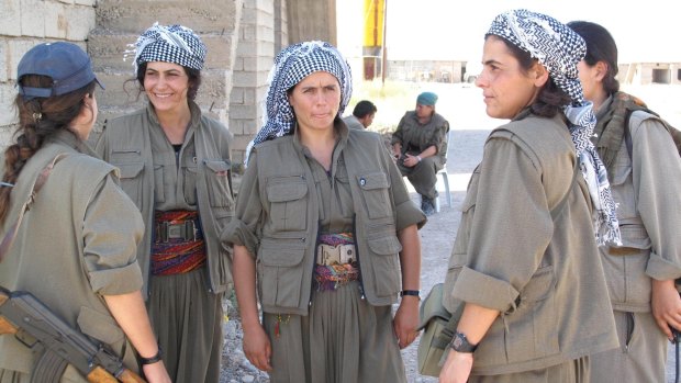 Commander Nuve Rojhat (centre) with some of the fighters in her unit at the Daquq PKK base.