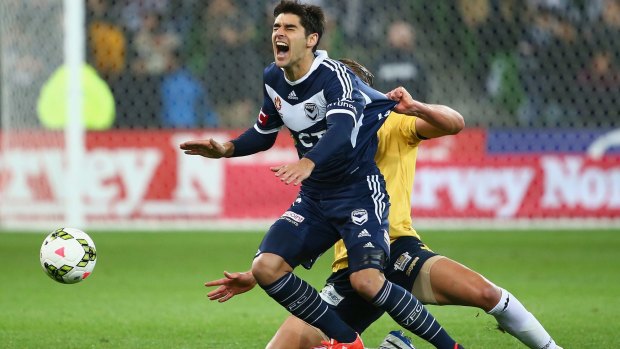 Two-goal hero Gui Finkler of the Victory is fouled by Zac Anderson of the Central Coast Mariners.