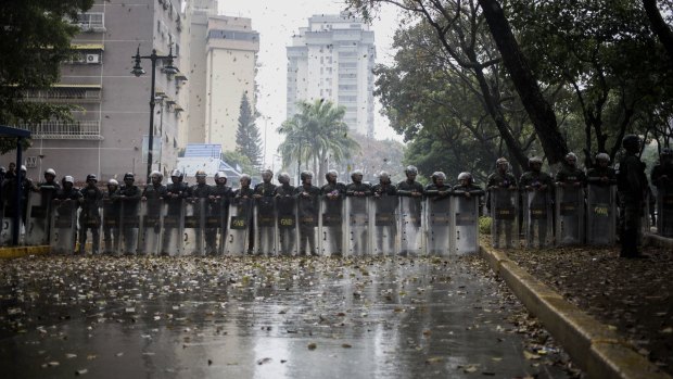 Security forces stand guard in Caracas.