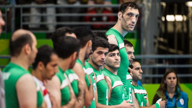Morteza Mehrzad of Iran's Paralympics sitting volleyball team, who measures just above eight feet looks on during the country's national anthem prior to a match against China at the Paralympics.