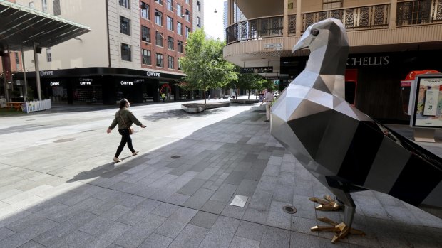 A women walks past the giant pigeon statue in an empty Rundle Mall as lockdown restrictions were imposed in Adelaide.