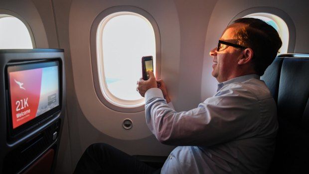 Qantas CEO Alan Joyce snaps a photo of the sunrise during the flight.