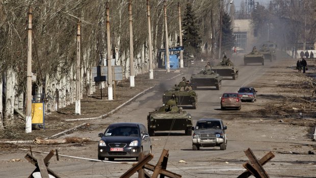 Russia-backed separatist drive a convoy of armoured vehicles in Vuhlehirsk. 