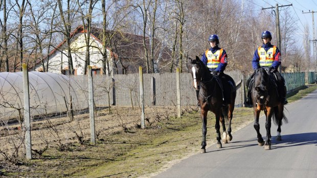 Mounted police officers patrol in  Morahalom, Hungary, near the Serbian border in February.
