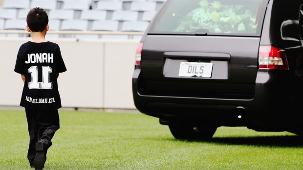 Jonah and Nadene's son Dhyreille Lomu follows the hearse as it departs the Public Memorial for Jonah Lomu.