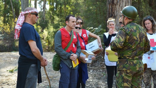 Keep talking. Shane Wilkes, centre, negotiates at a "checkpoint" at a Red Cross hostile environment training camp in Yellingbo, east of Melbourne.