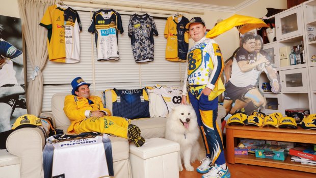 Trevor and Josh Hancock aka Brumbies Man and Brumbies Boy, at home with their dog Neo and part of their extensive Brumbies memorabilia collection