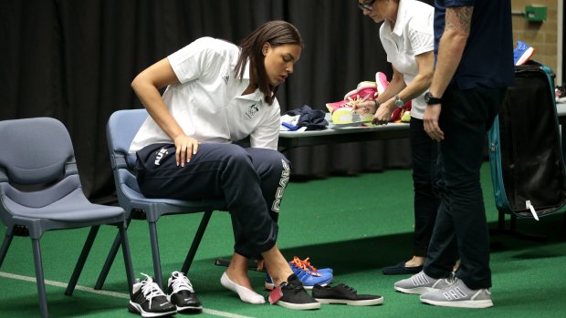Opals player Liz Cambage tries on some shoes at the AIS on Tuesday.  